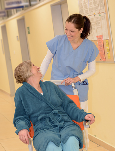 nurse smiles with woman in wheelchair