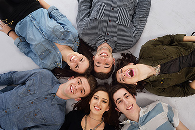 Group of happy people laying in a circle