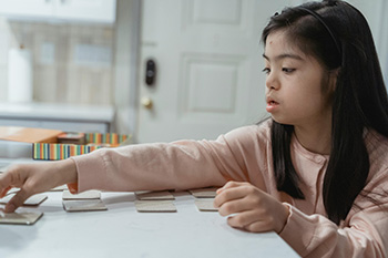 Young girl working on a puzzle